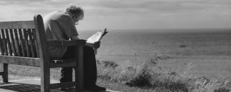 Elderly man sat on a bench