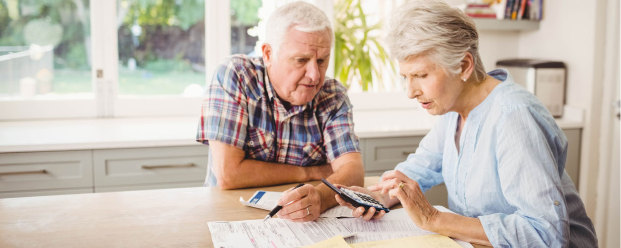 Elderly couple working out bills