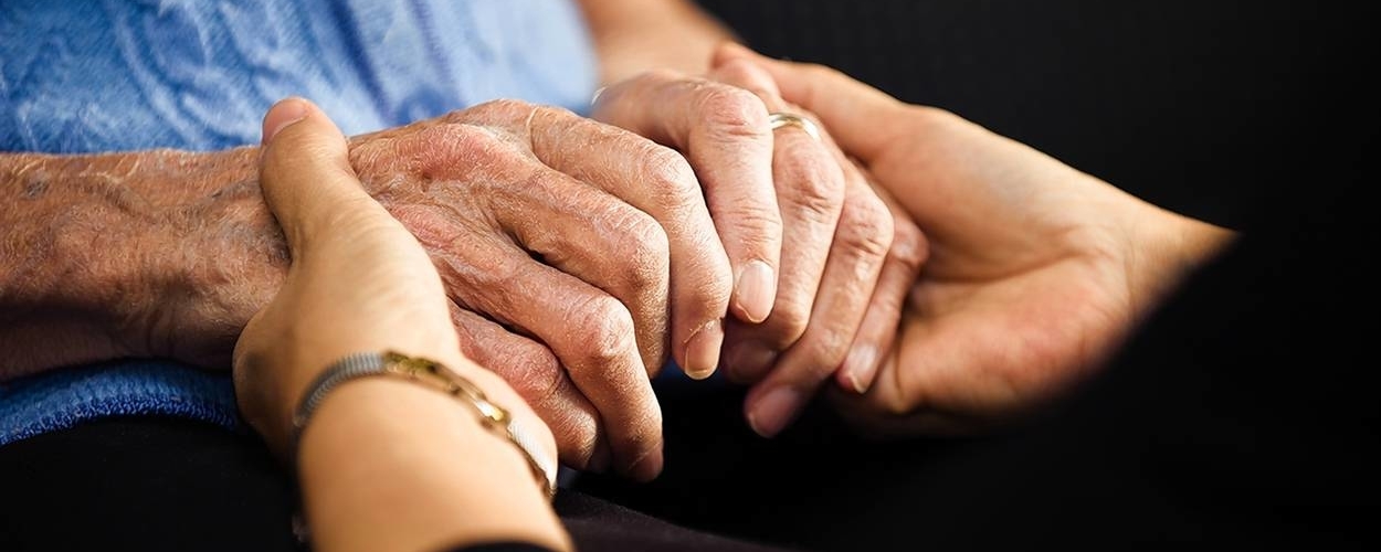 Elderly couple holding hands