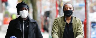 A couple wearing masks in a shop