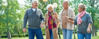 Four older people walking outside